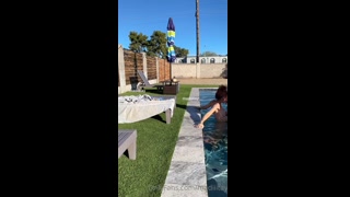Madiiitay is at a pool party, lounging on a chair, when she notices her friend playing in the water with her bikini top off